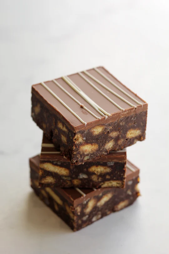 Stack of chocolate biscuit bars with white drizzle